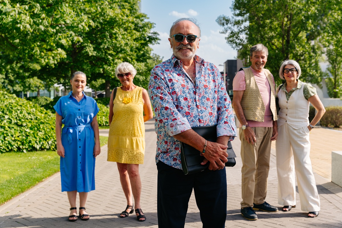 Szczęśliwi bezpieczni seniorzy na dworze przed domem seniora